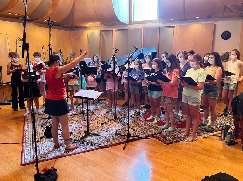 Group of young girls singing in a recording studio